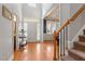 Bright foyer with hardwood floors, staircase, and transom windows above the front door at 4773 Swordfish Dr, Raleigh, NC 27603