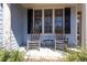 Inviting front porch featuring two rocking chairs and a small table for outdoor relaxation at 4773 Swordfish Dr, Raleigh, NC 27603