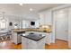 Open kitchen layout showcasing an island, stainless steel dishwasher, and a sink with a view of the outdoor patio at 4773 Swordfish Dr, Raleigh, NC 27603