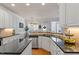 Well-lit kitchen with stainless steel appliances, white cabinets, granite countertops, and hardwood flooring at 4773 Swordfish Dr, Raleigh, NC 27603