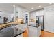 Bright kitchen with granite countertops, stainless steel appliances, a pantry, and adjacent breakfast bar at 4773 Swordfish Dr, Raleigh, NC 27603