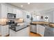 Modern kitchen featuring stainless steel appliances, granite counters, and ample storage in white cabinets at 4773 Swordfish Dr, Raleigh, NC 27603