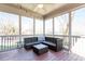 Enclosed screened porch with comfortable lounge furniture, ceiling fan, and backyard views at 4773 Swordfish Dr, Raleigh, NC 27603