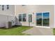 Freshly sodded backyard with new patio and view into the large sliding glass door of the townhome at 50 Sweet Meadow Rd, Angier, NC 27501