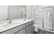 Bright bathroom featuring a double sink vanity and a glass enclosed shower with chrome accents at 50 Sweet Meadow Rd, Angier, NC 27501