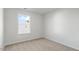Bedroom with bright window overlooking the neighborhood and neutral-colored carpet at 50 Sweet Meadow Rd, Angier, NC 27501