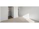 Bedroom showing neutral carpeting and paint with view into the bathroom with glass shower at 50 Sweet Meadow Rd, Angier, NC 27501
