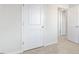 Hallway featuring two doors and neutral-colored carpeting at 50 Sweet Meadow Rd, Angier, NC 27501