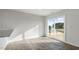 Open living area featuring light hardwood floors and a sliding glass door to the backyard at 50 Sweet Meadow Rd, Angier, NC 27501