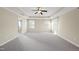 Large main bedroom featuring trey ceiling, ample windows, and plush carpet flooring at 504 Copper Beech Ln, Wake Forest, NC 27587