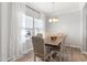 Bright dining room featuring a wood table, six chairs, and a window with curtains at 509 Horseman Park Pl, Wendell, NC 27591