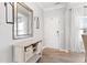 Bright entryway featuring wood-look floors, console table with mirror, and front door at 509 Horseman Park Pl, Wendell, NC 27591