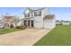 Charming two-story home with a well-manicured lawn, two-car garage, and inviting front porch at 509 Horseman Park Pl, Wendell, NC 27591