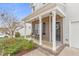 Inviting front porch with brick columns and black door with a decorative wreath at 509 Horseman Park Pl, Wendell, NC 27591