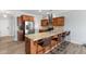 Modern kitchen boasting stainless steel appliances, breakfast bar with seating, and wood cabinets at 509 Horseman Park Pl, Wendell, NC 27591
