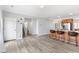 Spacious living area featuring wood-look flooring, a staircase, and open access to the kitchen at 509 Horseman Park Pl, Wendell, NC 27591