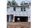 Unfinished townhouse shows the framing and structure, pre-drywall, with the garage visible at 6964 Doddridge Ln # 13, Cary, NC 27519