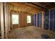 Unfinished bedroom shows exposed framing, blue sheathing, and windows, ready for customization at 6966 Doddridge Ln # 12, Cary, NC 27519