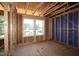 This is an unfinished bedroom featuring exposed framing, blue sheathing, and windows, ready for customization at 6966 Doddridge Ln # 12, Cary, NC 27519