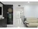 Inviting hallway with stylish decor, leading to a well-lit entrance and comfortable seating area at 7205 Sandy Creek Dr, Raleigh, NC 27615