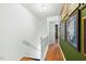 Hallway with white walls and wooden floors, adorned with framed artwork at 7205 Sandy Creek Dr, Raleigh, NC 27615