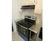 Close-up of kitchen stove with stainless steel countertops and white cabinets at 7205 Sandy Creek Dr, Raleigh, NC 27615