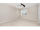 Neutral bedroom with ceiling fan, carpet, and a bright window at 7213 Terregles Dr, Raleigh, NC 27617