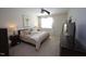Comfortable bedroom with neutral carpet, ceiling fan, and a large window at 7213 Terregles Dr, Raleigh, NC 27617