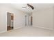 Spacious, neutral bedroom featuring an ensuite bathroom, ceiling fan and large closet at 7213 Terregles Dr, Raleigh, NC 27617