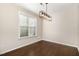 Bright dining area with modern light fixture and hardwood floors at 7213 Terregles Dr, Raleigh, NC 27617