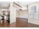 Open dining area leading to kitchen and living space, hardwood floors, and bright window at 7213 Terregles Dr, Raleigh, NC 27617