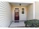 Front entryway with a decorative wreath and well-kept shrubbery at 7213 Terregles Dr, Raleigh, NC 27617