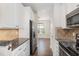 Contemporary kitchen boasts stainless steel appliances and ample counter space at 7213 Terregles Dr, Raleigh, NC 27617