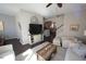 Open living space features a large TV, neutral paint and is open to the staircase and kitchen at 7213 Terregles Dr, Raleigh, NC 27617