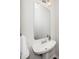 Bathroom featuring a pedestal sink, large mirror, and modern light fixture at 7753 Winners Edge St, Raleigh, NC 27617