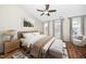 Staged bedroom with natural light, a ceiling fan, and warm neutral tones at 7753 Winners Edge St, Raleigh, NC 27617