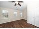 Bright bedroom featuring hardwood floors, ceiling fan, double-door closet, and multiple windows offering lots of natural light at 7753 Winners Edge St, Raleigh, NC 27617