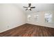 Bright bedroom with hardwood floors, neutral paint, and multiple windows at 7753 Winners Edge St, Raleigh, NC 27617
