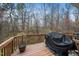 Wooden deck with railings overlooking a wooded backyard and a grill with cover at 7753 Winners Edge St, Raleigh, NC 27617