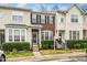 Charming townhome featuring a brick facade, black shutters, and a well-manicured front yard at 7753 Winners Edge St, Raleigh, NC 27617