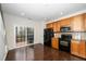 Bright kitchen featuring wood cabinets, black appliances, and sliding glass doors to the deck at 7753 Winners Edge St, Raleigh, NC 27617