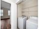 Convenient laundry area featuring a washer, dryer, and shelving for easy storage at 7753 Winners Edge St, Raleigh, NC 27617