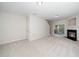 Carpeted living room with a fireplace, sliding glass doors, and white trim at 7753 Winners Edge St, Raleigh, NC 27617