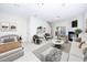 Well-lit living room with a fireplace, comfortable seating, and a bedroom area at 7753 Winners Edge St, Raleigh, NC 27617