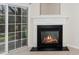 Fireplace with a white mantle and sliding glass door that opens to outside at 7753 Winners Edge St, Raleigh, NC 27617