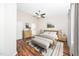 Staged main bedroom with a bed, dresser, and an ensuite bathroom visible through the doorway at 7753 Winners Edge St, Raleigh, NC 27617