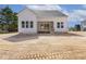 Backyard view of a two-story white home featuring a screened porch and ample yard space at 9000 Penny Rd, Raleigh, NC 27606