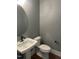 Clean bathroom features a pedestal sink, toilet, and minimalist design, creating a functional space at 9000 Penny Rd, Raleigh, NC 27606