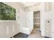 New bathroom with a bench in the shower, tile floors and a large window at 9000 Penny Rd, Raleigh, NC 27606