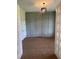 Well-lit room with gray wall paneling, modern light fixture and white french doors offers a versatile space at 9000 Penny Rd, Raleigh, NC 27606